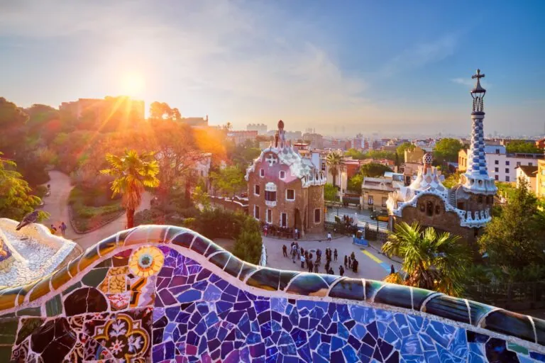Barcelona city view from Guell Park. Sunrise view of colorful mosaic building in Park Guell